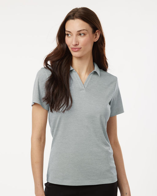 Woman wearing a gray polo shirt on a white background