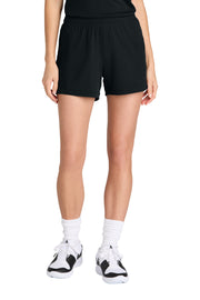 Person wearing black shorts and white sneakers on a white background